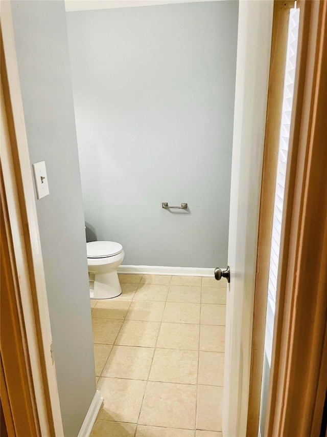 bathroom with toilet and tile patterned floors