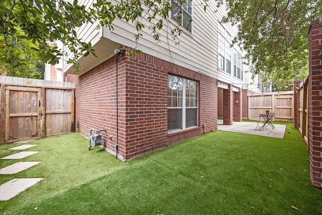 view of home's exterior with a lawn and a patio area