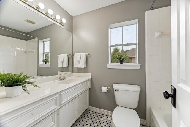 full bathroom with vanity, toilet, and tiled shower / bath combo