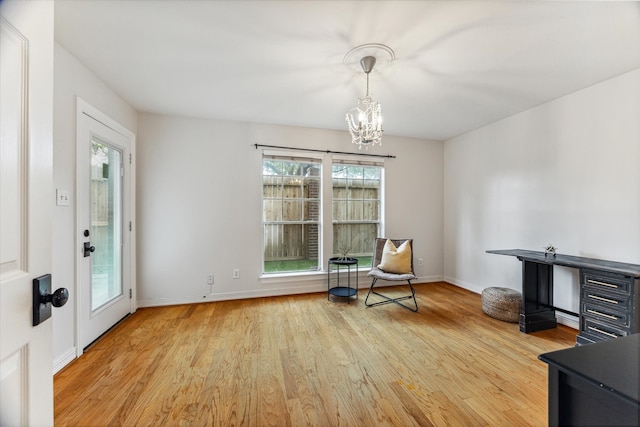 sitting room with a chandelier and hardwood / wood-style floors