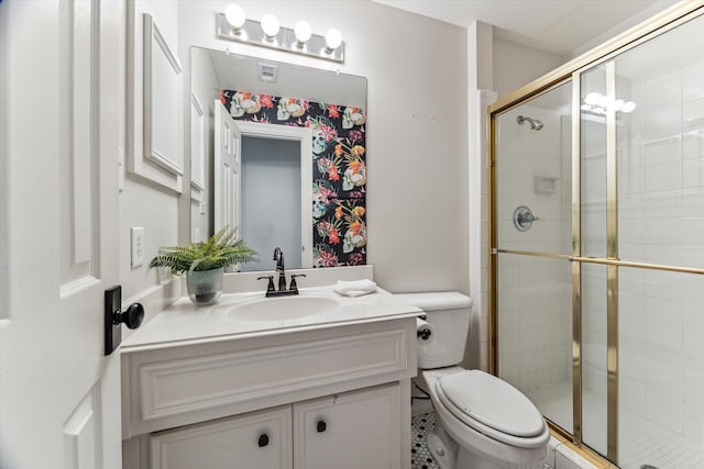 bathroom with toilet, vanity, and walk in shower