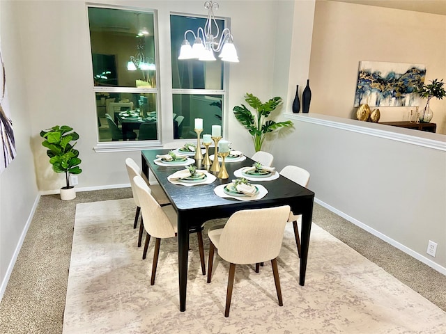 dining room with carpet and an inviting chandelier