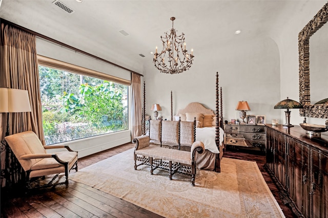 bedroom featuring hardwood / wood-style floors and a notable chandelier