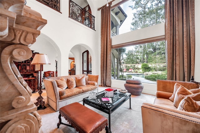 living room with light colored carpet and a high ceiling