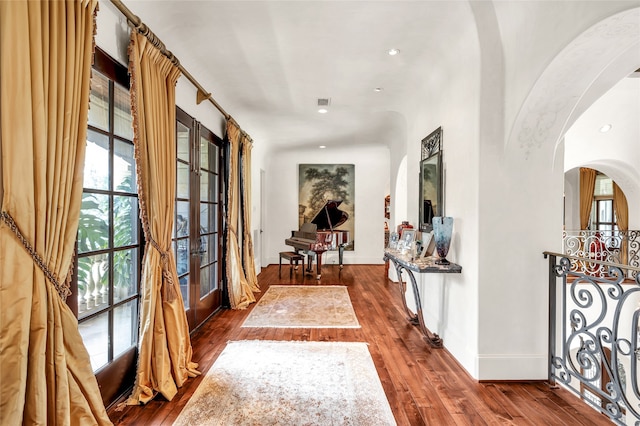 hallway featuring french doors and dark wood-type flooring