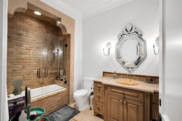 full bathroom featuring tile patterned floors, vanity, crown molding, enclosed tub / shower combo, and toilet