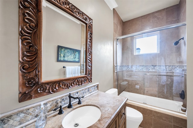 full bathroom with vanity, toilet, and shower / bath combination with glass door