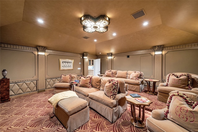 carpeted home theater featuring vaulted ceiling