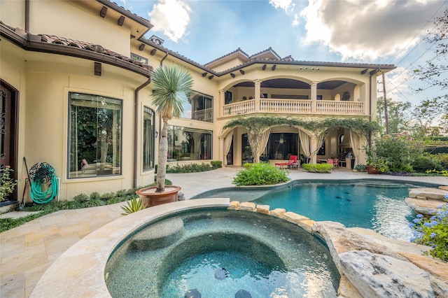 view of pool featuring an in ground hot tub and a patio area