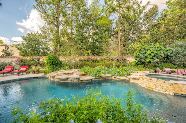 view of swimming pool with an in ground hot tub