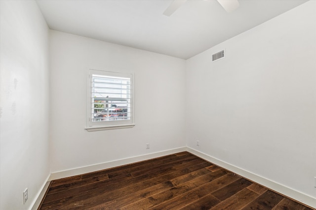 spare room with ceiling fan and dark hardwood / wood-style flooring