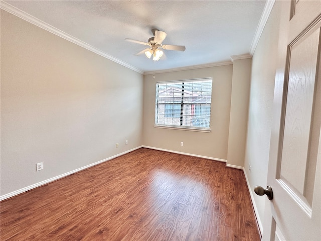 spare room with dark hardwood / wood-style flooring, ceiling fan, and ornamental molding