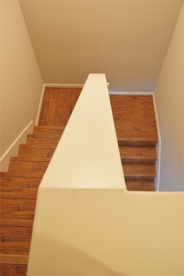 stairs featuring wood-type flooring