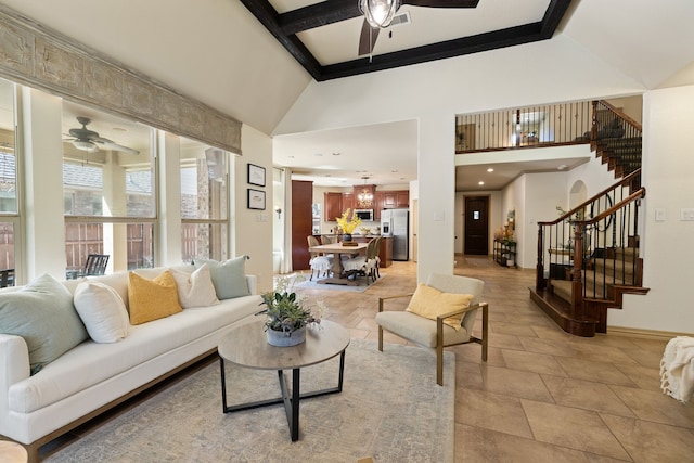 living room with beamed ceiling, ceiling fan, light tile patterned floors, and a towering ceiling