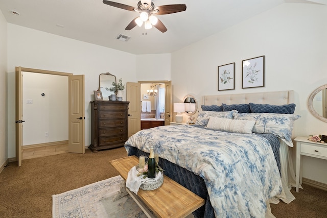 bedroom with ceiling fan with notable chandelier, light colored carpet, and lofted ceiling