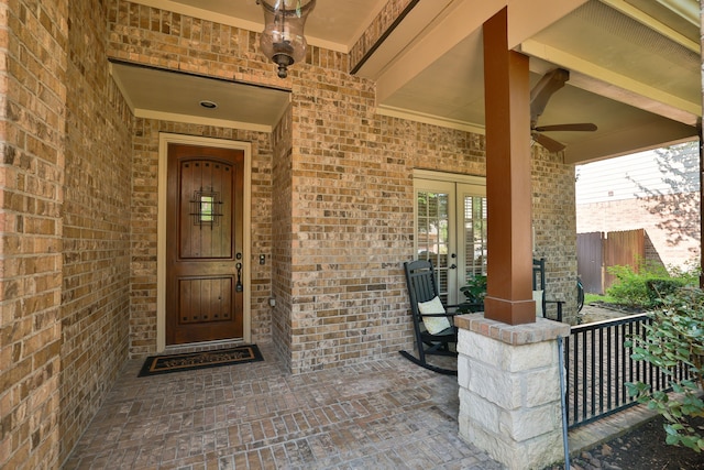 property entrance featuring ceiling fan, french doors, and covered porch