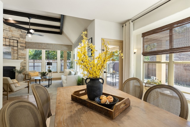 interior space with vaulted ceiling with beams, plenty of natural light, and ceiling fan