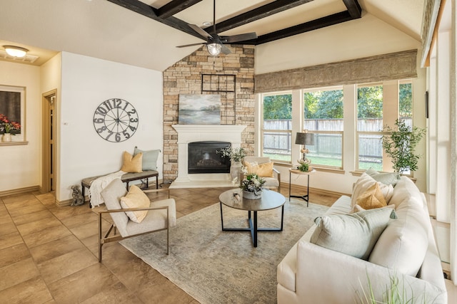 living room with a fireplace, vaulted ceiling with beams, and ceiling fan