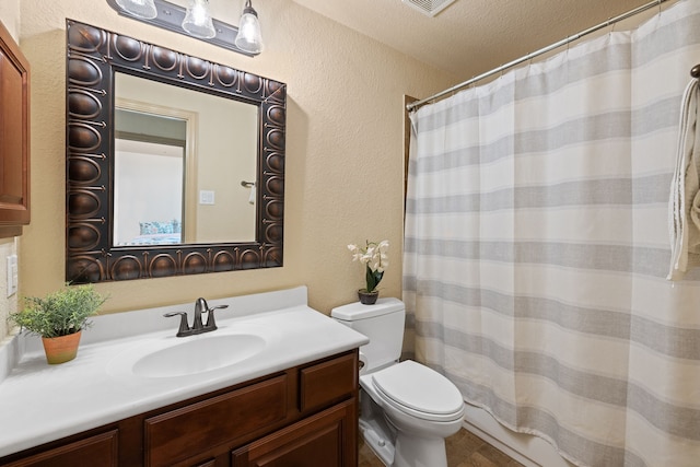 bathroom with vanity, a textured ceiling, toilet, and a shower with shower curtain