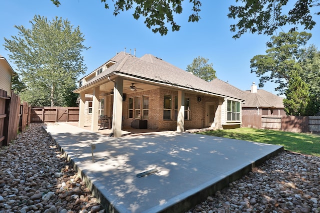 rear view of house with ceiling fan and a patio