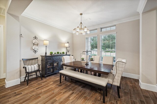 dining room featuring a chandelier, hardwood / wood-style floors, and ornamental molding