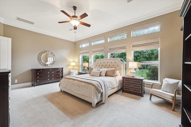 bedroom featuring light carpet, ceiling fan, and crown molding