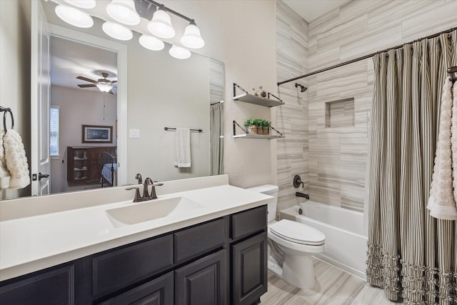 full bathroom with ceiling fan, shower / tub combo with curtain, vanity, and toilet