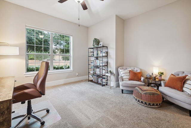 carpeted office space featuring ceiling fan