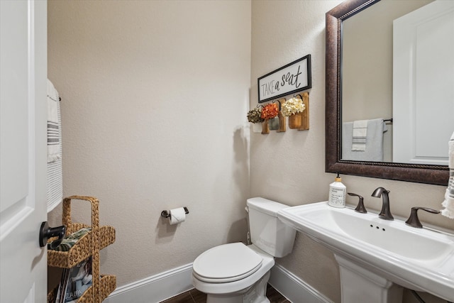 bathroom featuring toilet and sink