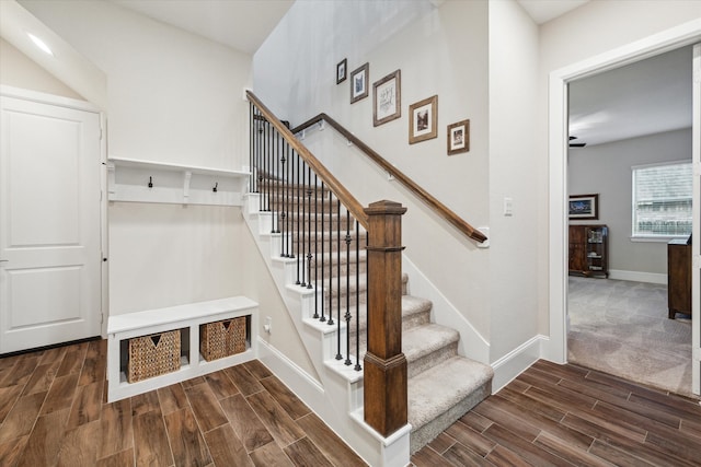 stairway with ceiling fan and hardwood / wood-style floors