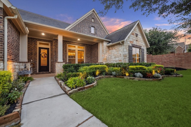 view of front of house with a lawn and a porch