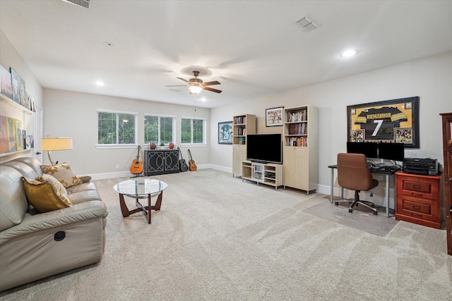 carpeted living room with ceiling fan