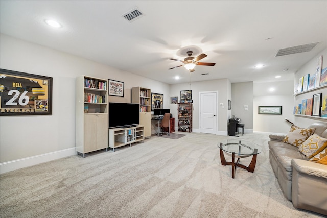 carpeted living room with ceiling fan