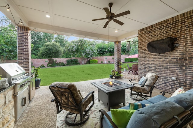 view of patio featuring a grill, ceiling fan, area for grilling, and an outdoor living space with a fire pit