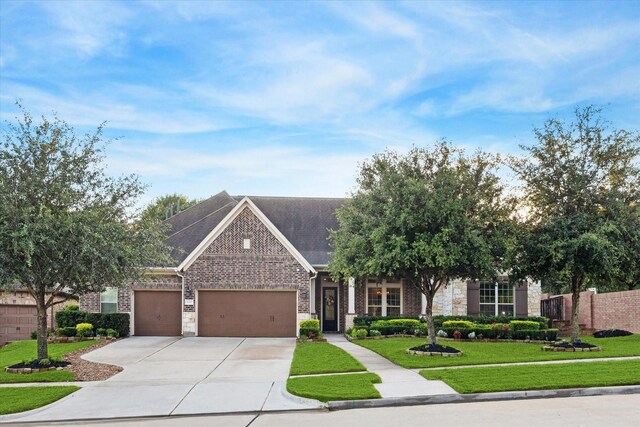 view of front of property featuring a garage and a front lawn