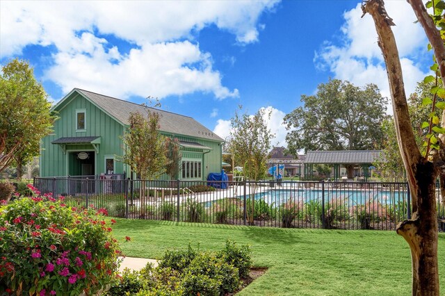 view of pool with a yard