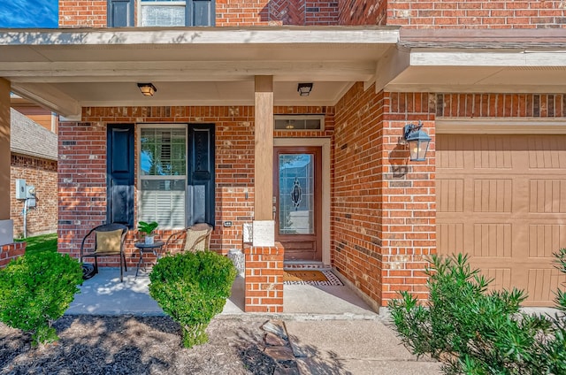 view of exterior entry with a porch