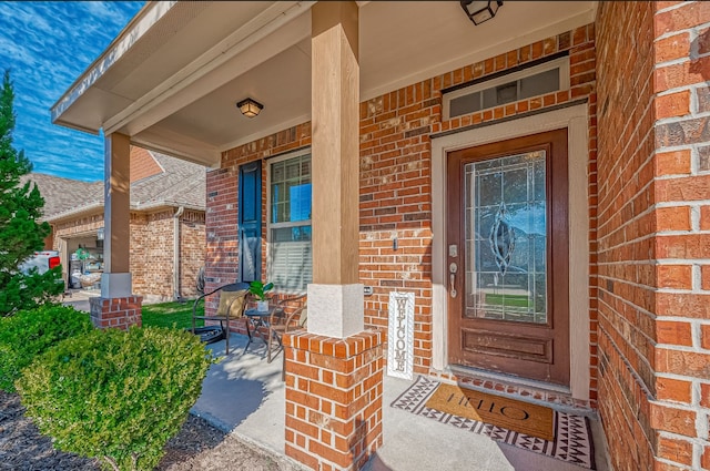 view of exterior entry featuring a porch