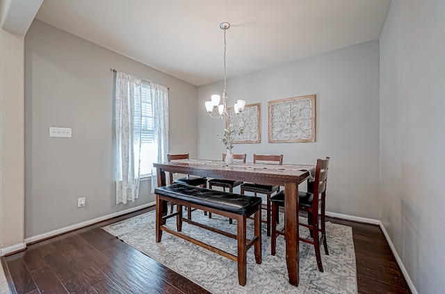 dining room featuring a chandelier and dark wood-type flooring