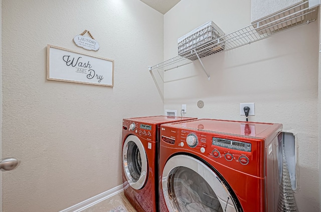 clothes washing area featuring washer and dryer