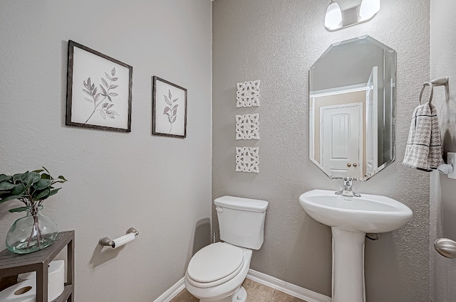 bathroom featuring tile patterned floors and toilet