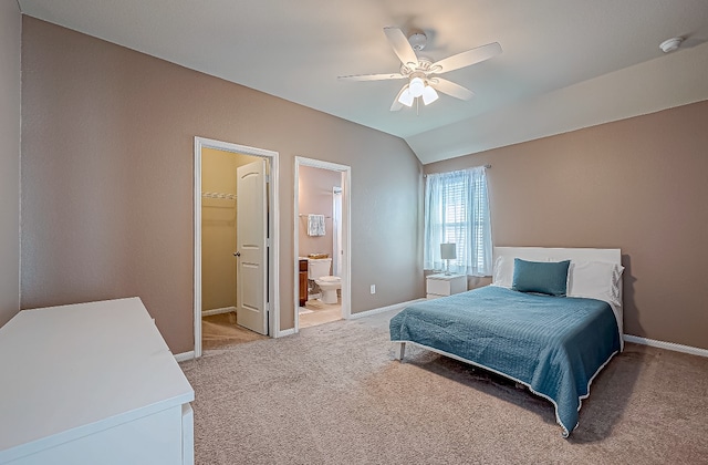 bedroom with ensuite bath, ceiling fan, a spacious closet, light colored carpet, and a closet