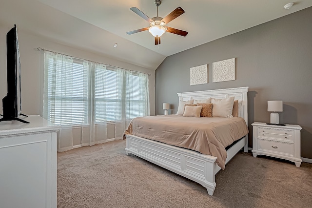 bedroom featuring ceiling fan, light colored carpet, and vaulted ceiling