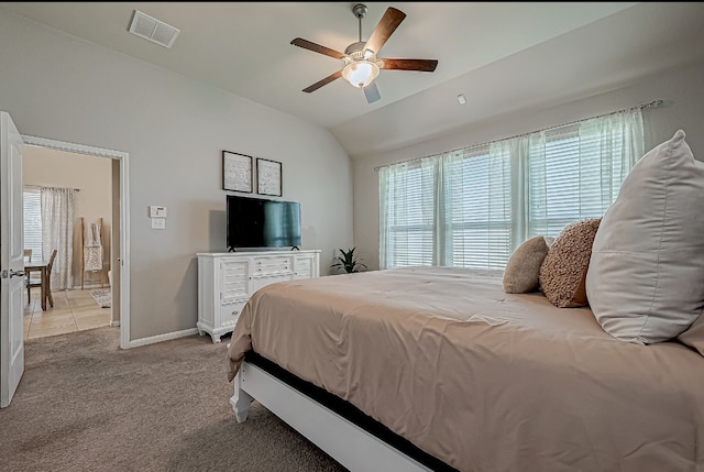 carpeted bedroom with ceiling fan and lofted ceiling