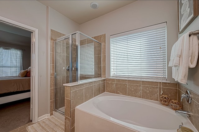 bathroom featuring separate shower and tub