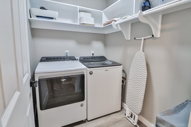 washroom featuring light wood-type flooring and independent washer and dryer