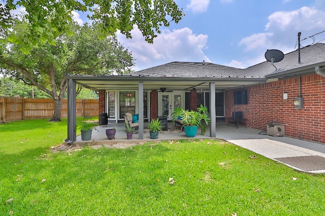 rear view of house featuring a lawn, ceiling fan, outdoor lounge area, and a patio