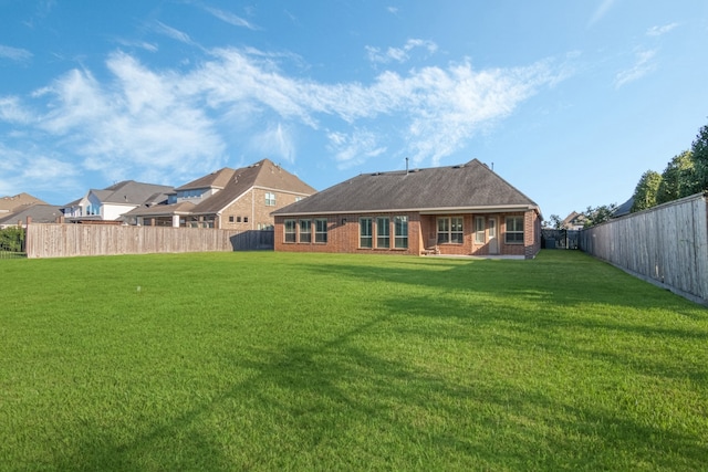 rear view of house with a yard