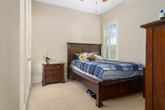 bedroom with ceiling fan and light tile patterned flooring