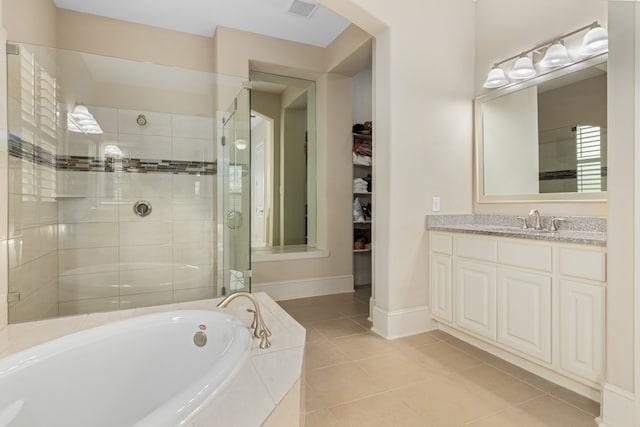 bathroom with tile patterned floors, vanity, and independent shower and bath